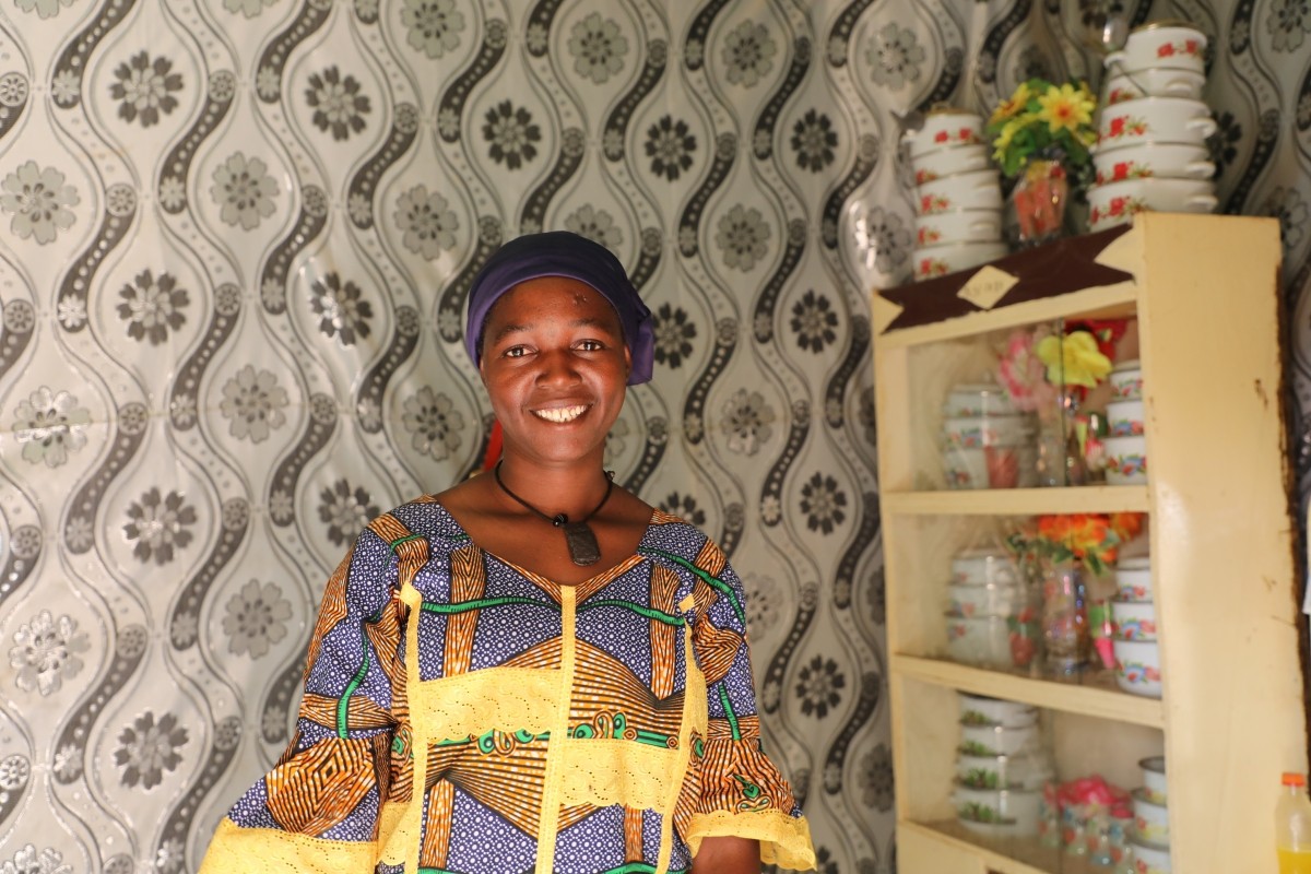 A woman smiles in her home