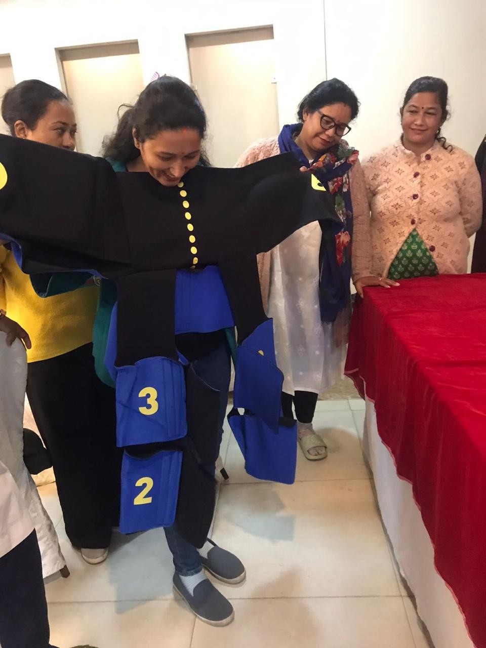 Nurse Puspa Oli practices using the non-pneumatic antishock garment (NASG) during project training.