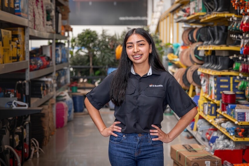 Dayana Fuentes proudly stands at her new job.