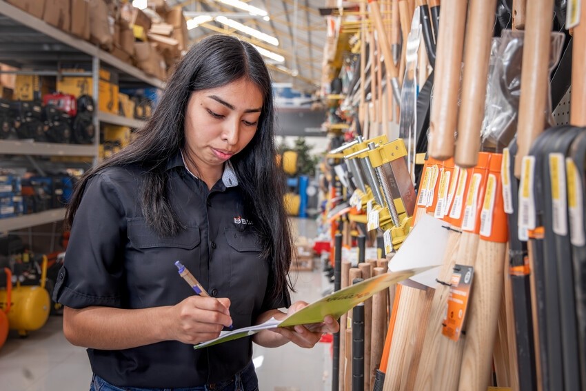 Dayana Fuentes records inventory at El Baratillo, a large hardware store, in western Honduras.