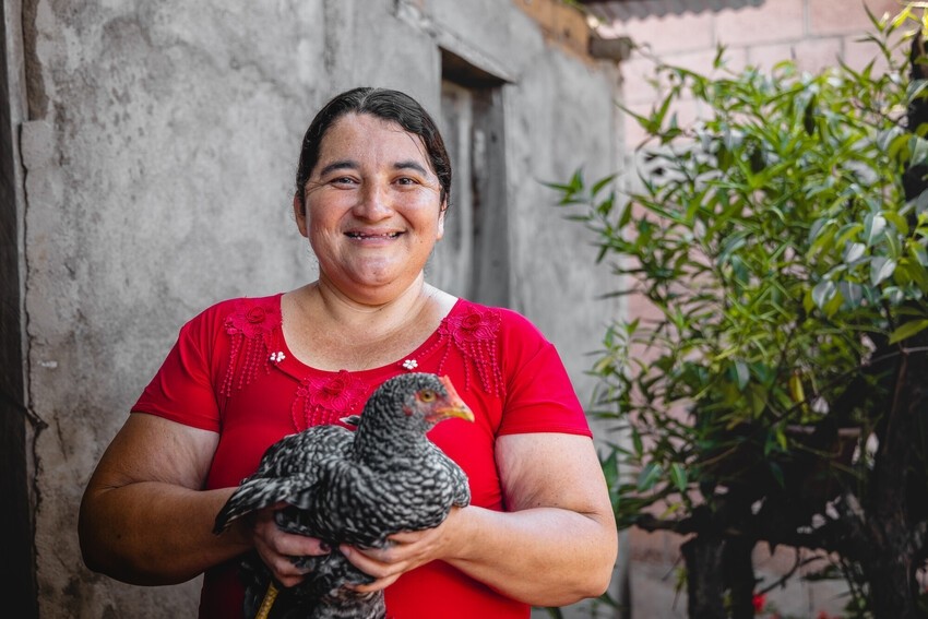 Marta holds one of her chickens.