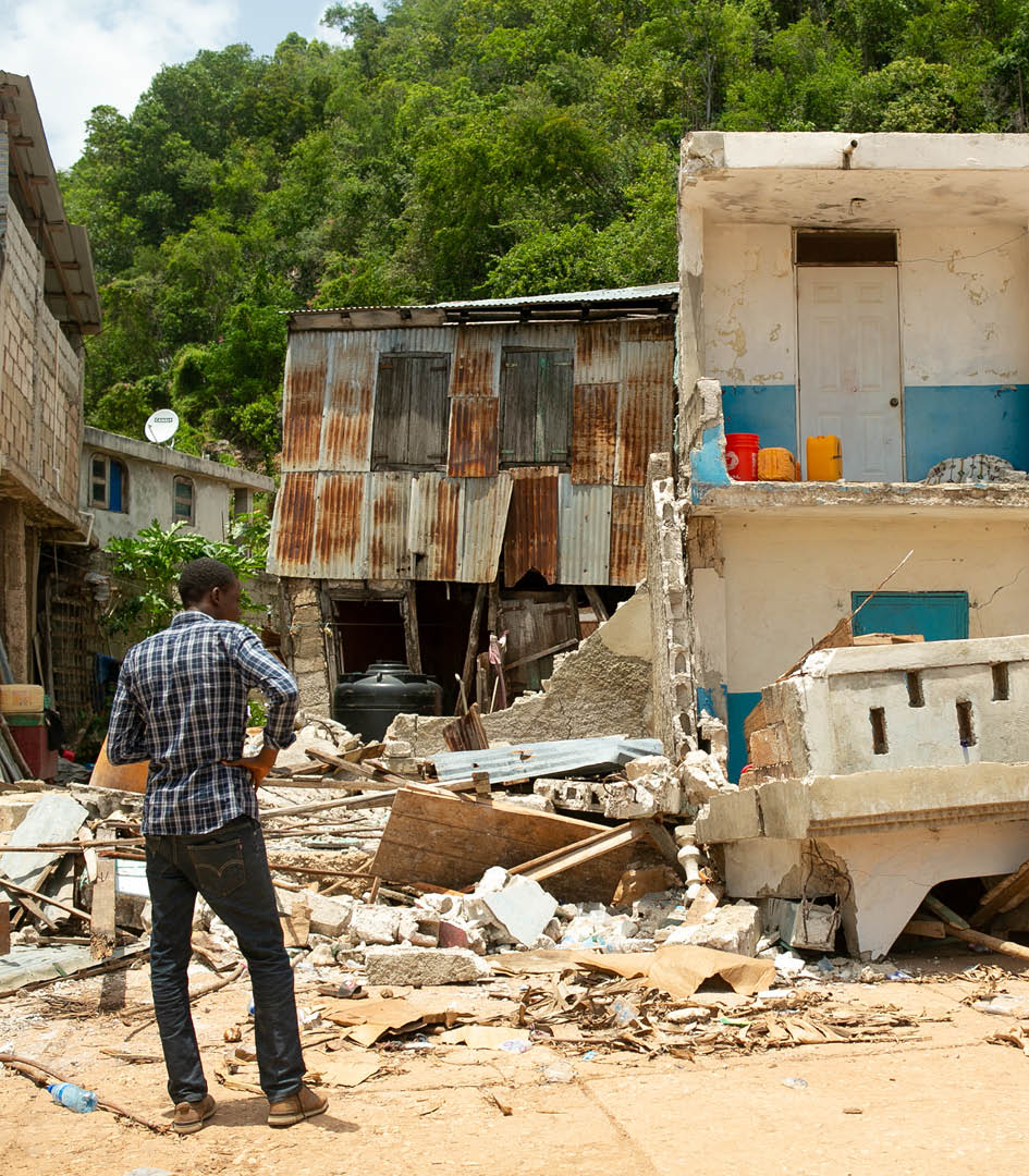 Homes and businesses lie in ruins in the fishing village of Pestel in the Grand Anse department of Haiti, after the August 14 quake, on August 24, 2021  (Photo by Allison Shelley for LWR Corus)