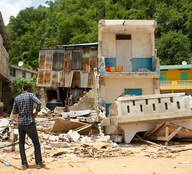 Homes and businesses lie in ruins in the fishing village of Pestel in the Grand Anse department of Haiti, after the August 14 quake, on August 24, 2021  (Photo by Allison Shelley for LWR Corus)